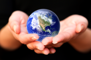 Hands holding a small Earth