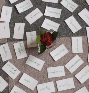 needs cards around a flower in a vase